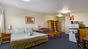 a hotel room with a bed and a kitchen at Alpine Heights 28 in Mount Hotham