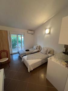 two beds in a room with a window at SNG Apartmani in Brca