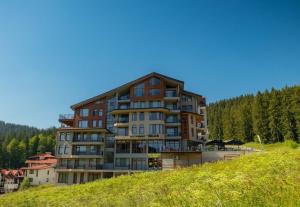 a large building on top of a hill at The Bear Pamporovo in Pamporovo