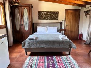 a bedroom with a bed and a rug at Villa Umami in Makri