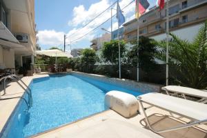 a swimming pool in the middle of a building at Liberty Hotel in Rethymno