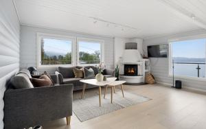 a living room with a couch and a fireplace at The Green Bay in Sandnes