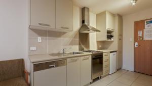 a kitchen with a sink and a stove top oven at Chalet Hotham 8 in Mount Hotham
