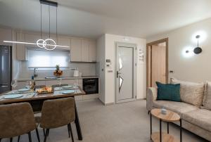 a living room and kitchen with a couch and a table at fa & f in Argostoli