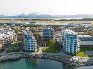 an aerial view of a city with buildings and water at Central Apartment in Bodø with ocean view in Bodø