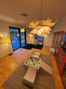 a living room with a couch and a chandelier at Archipelag in Ustka