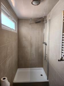 a bathroom with a tub and a shower with a window at Accessible Norton road in Stockton-on-Tees
