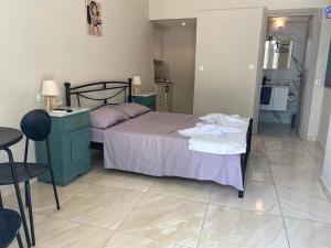 a bedroom with a bed and a table and a chair at lacasadirigas in Lefkada
