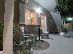 a patio with a table and chairs in a house at lacasadirigas in Lefkada