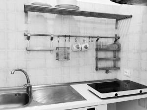 a kitchen with a sink and a counter top at Appartamento - Trieste in Trieste