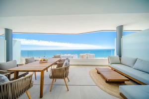 a living room with a table and a couch at Sea Views Apartment Lucy in Fuengirola