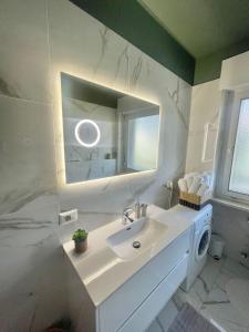 łazienka z umywalką i lustrem w obiekcie Residenza XXX Aprile w Meranie +6 zdjęć