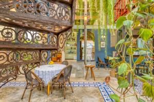 a dining room with a table and chairs at Priya Boutique House in Bangkok