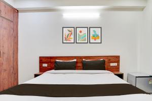 Postel nebo postele na pokoji v ubytování Collection O Sunshine Corporate Suite