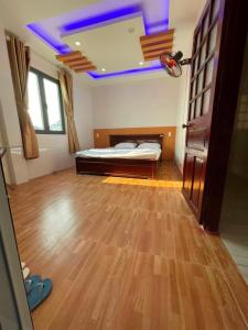 a bedroom with a bed and a ceiling with purple lights at Trung Hiếu Hotel - bên cạnh Miếu Bà Chúa Xứ in Chau Doc