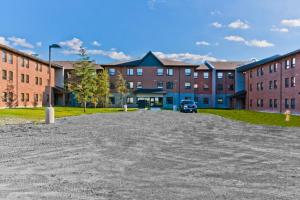 an empty parking lot in front of a building at Residence & Conference Centre - Sudbury North in Sudbury