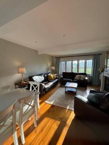 a living room with a couch and a table at Picturebook cottage on prestigious polo estate in Stedham