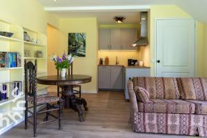 a living room with a couch and a table and a kitchen at OV592- 2P apartment in the heart of Giethoorn in Giethoorn