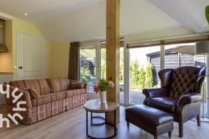 a living room with a couch and a chair at OV592- 2P apartment in the heart of Giethoorn in Giethoorn