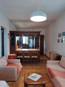 a living room with a couch and a table at Psakoudia old olive trees appartment 50 m2, 2 bedrooms, sea view in Psakoudia