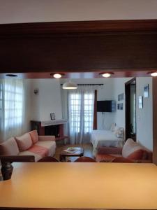 a living room with a couch and a bed at Psakoudia old olive trees appartment 50 m2, 2 bedrooms, sea view in Psakoudia