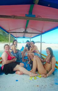 a group of people sitting on the beach at Boat Trip in Riung