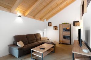 a living room with a couch and a table at Ferienoase Im Land Der 1000 Seen in Karstädt