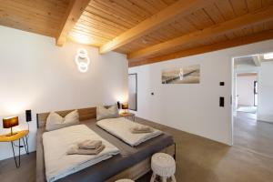 a bedroom with two beds and a wooden ceiling at Ferienoase Im Land Der 1000 Seen in Karstädt