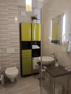 a bathroom with a sink and a toilet and a mirror at Keti House Apartments in Vela Luka +34 photos