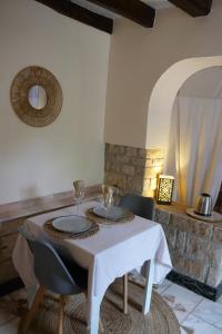 a white table with chairs and a white table cloth at Le Nid du Cormier in Ville-Saint-Jacques