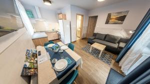 a living room with a table and a couch at ArZa Sóstó Apartman in Nyíregyháza