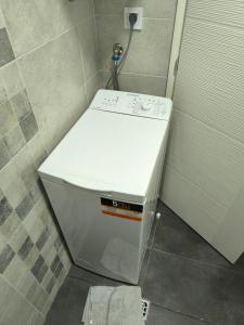 a washing machine sitting in a bathroom next to a door at Apartmani Mijović in Herceg-Novi