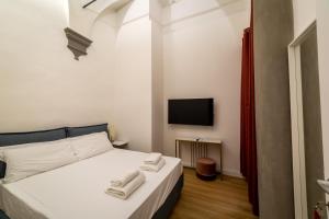 A bed or beds in a room at Residenza d'Epoca Galleria dell'Accademia