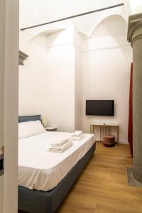 A bed or beds in a room at Residenza d'Epoca Galleria dell'Accademia