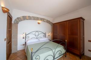 a bedroom with a bed and a wooden cabinet at Casa Allegra in Praiano +39 photos