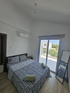 a bedroom with a bed and a sliding glass door at Trendy Holiday Villa 38 Larnaca, Pyla in Larnaka