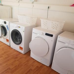 a laundry room with three washing machines and a washer and dryer at Charmante Monteurwohnung in Geislingen an der Steige