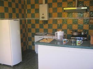 a kitchen with a refrigerator and a counter top at Cabañas Caleta San Pedro in La Serena