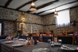a dining room with a table and chairs and a table and chairs at Corbadziski An Ethno House in Tetovo