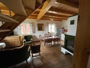 a kitchen and dining room with a table and a fireplace at Brzezina Resort - Wille in Żnin