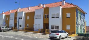 a white car parked in front of a building at Apartamento Fazunchar in Figueiró dos Vinhos