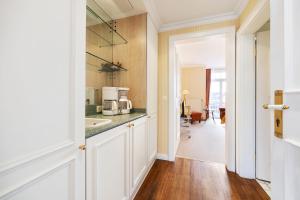 a kitchen with a sink and a counter top at Strandhotel Sylt Westerland in Westerland