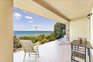 a patio with a view of the ocean at Aventino Costa Verde - Gutturu in Marina di Arbus
