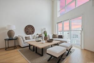 a living room with white furniture and a large window at Luxury 3 bedroom seaview apartment, ONS 2024 in Stavanger