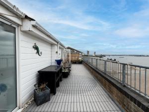 a balcony of a house with a view of the water at Windrush Court · Stunning Penthouse With River Views Near Erith Stn Pass The Keys in Erith