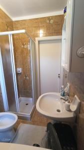 a bathroom with a shower and a sink and a toilet at Appartamento Aviano in Aviano +24 photos