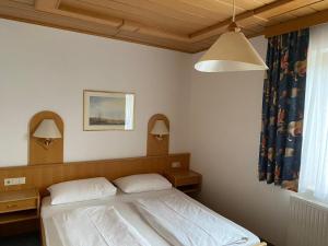 a bedroom with a bed with two pillows at Die Herberge in Podersdorf am See