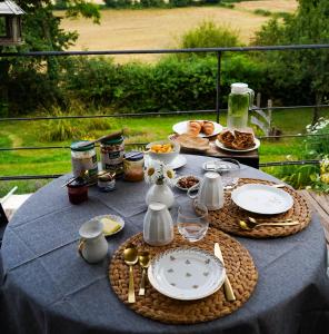 a table with plates of food on top of it at Le Petit Pré in Bouhy