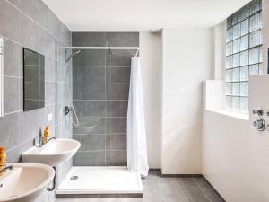 a bathroom with a shower and a sink at T&K Apartments - 2 - 5 Room Apartments - Heart of Solingen-Hofgarten in Solingen +70 photos