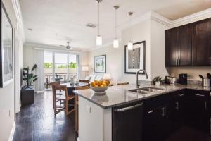 a kitchen with a counter with a bowl of oranges on it at Century Millenia in Orlando in Orlando